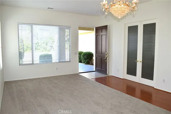 an empty room with windows and entrance