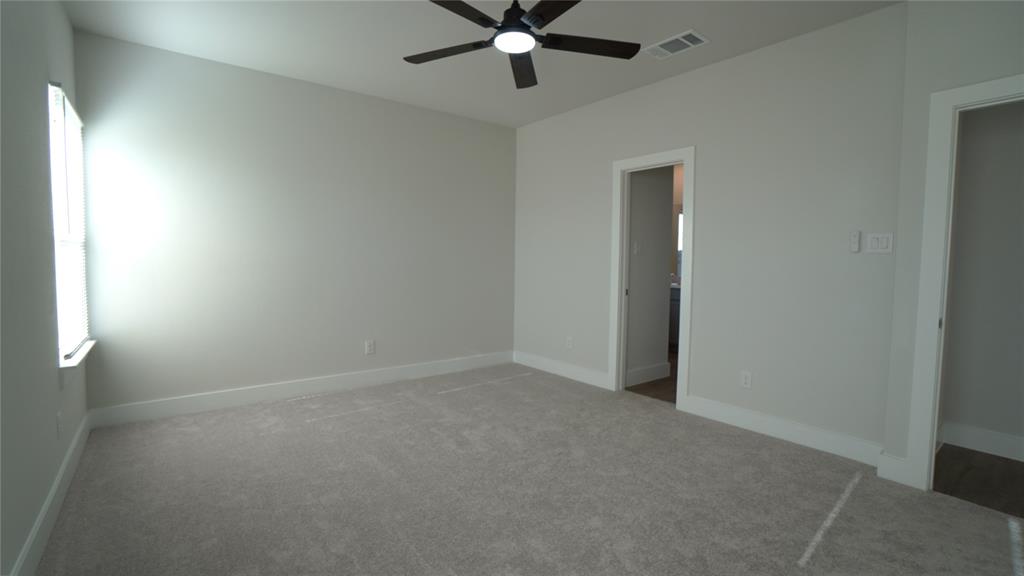 1374 Chisos Way Forney, TX 75126 - Photo 14 of 25 an empty room with a ceiling fan and a window