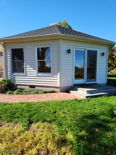 122 Boss Road, Unit B Stockton, NJ 08559 - Photo 1 of 10 a front view of a house with a yard