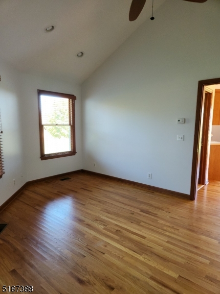 122 Boss Road, Unit B Stockton, NJ 08559 - Photo 2 of 10 an empty room with wooden floor and windows