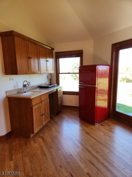 122 Boss Road, Unit B Stockton, NJ 08559 - Photo 5 of 10 a kitchen with stainless steel appliances granite countertop a sink a refrigerator and wooden cabinets
