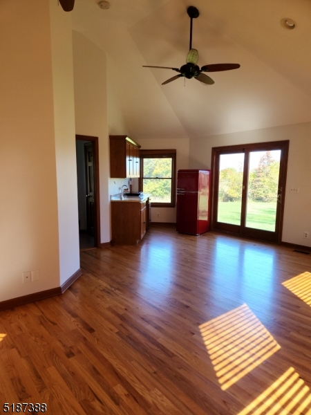 122 Boss Road, Unit B Stockton, NJ 08559 - Photo 8 of 10 a view of a livingroom with hardwood floor and a ceiling fan