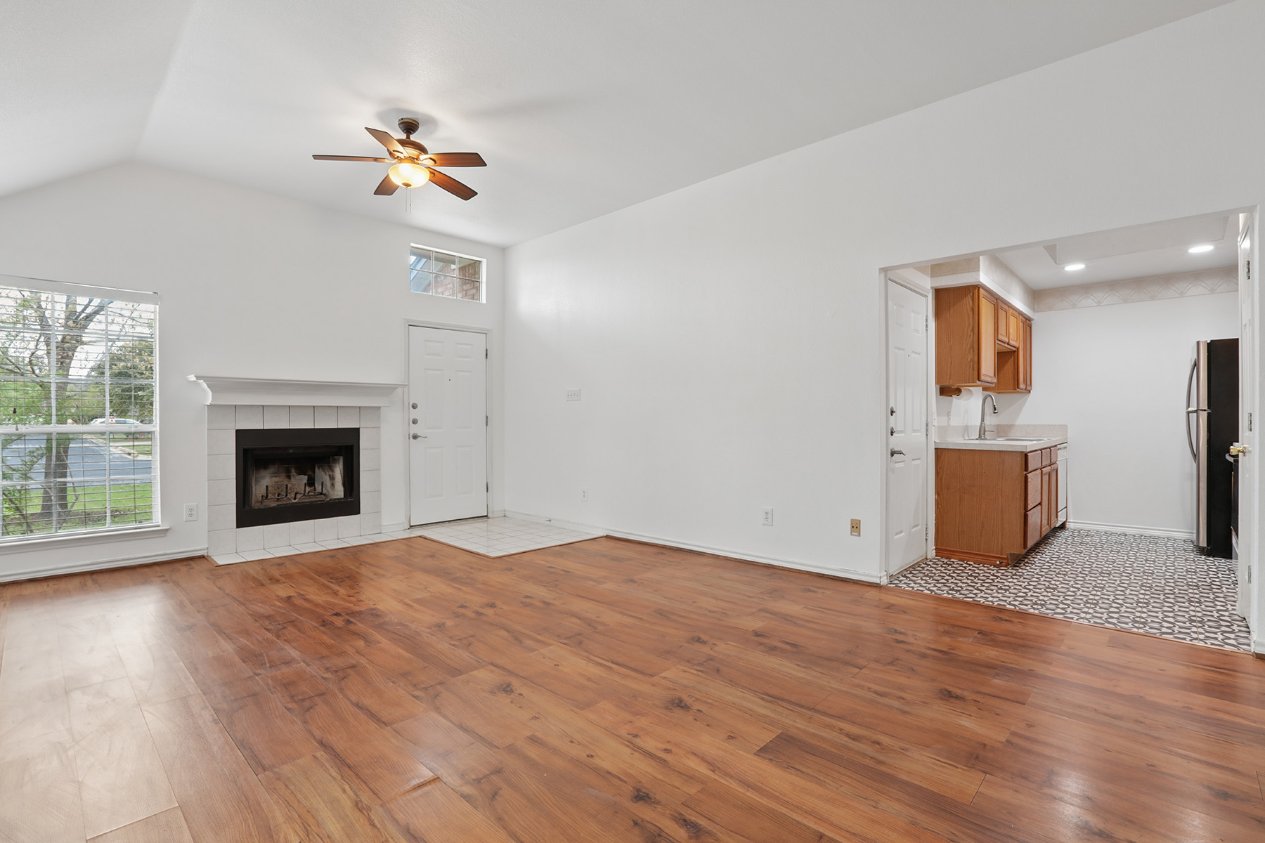 12319 Turtle Rock Road, Unit B Austin, TX 78729 - Photo 11 of 26 a view of empty room with wooden floor and fireplace