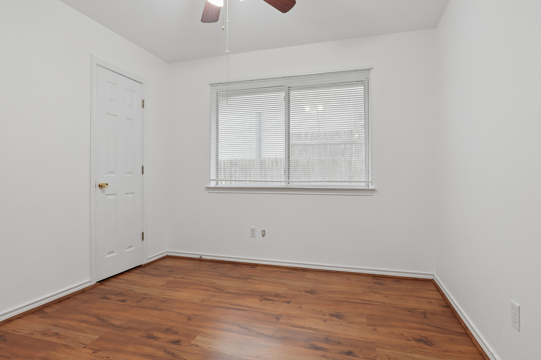 12319 Turtle Rock Road, Unit B Austin, TX 78729 - Photo 13 of 26 an empty room with wooden floor and windows
