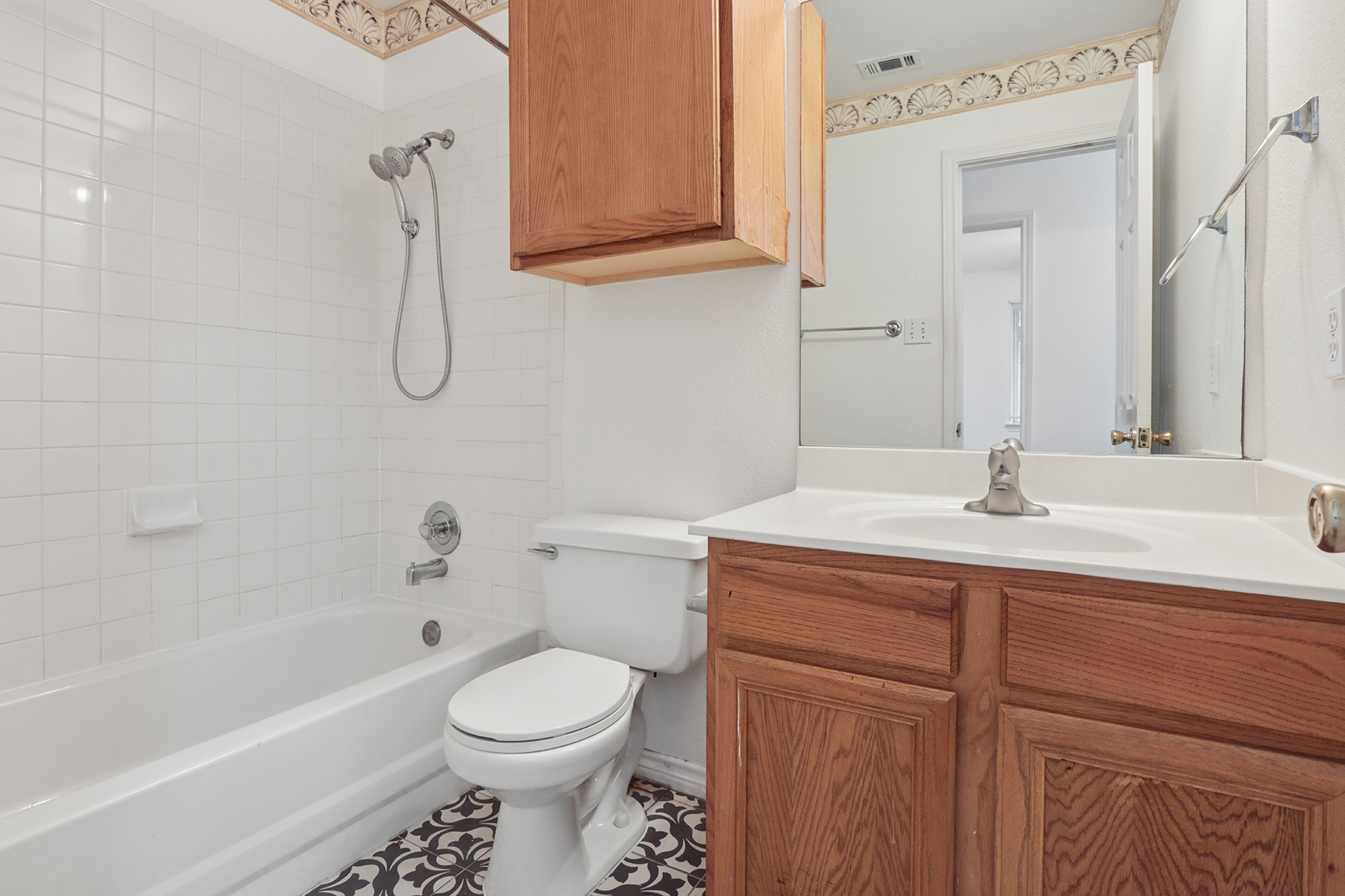 12319 Turtle Rock Road, Unit B Austin, TX 78729 - Photo 14 of 26 a bathroom with a sink a toilet and shower