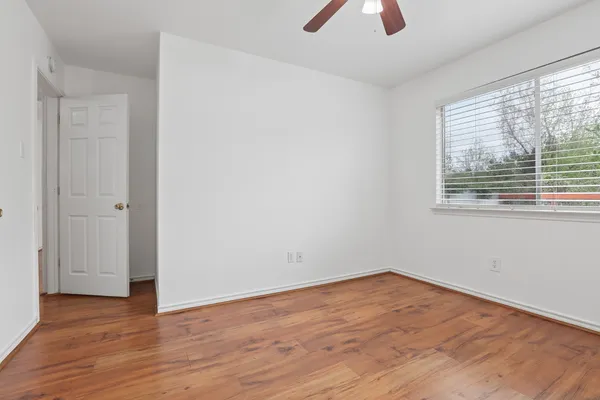 wooden floor in an empty room with a window