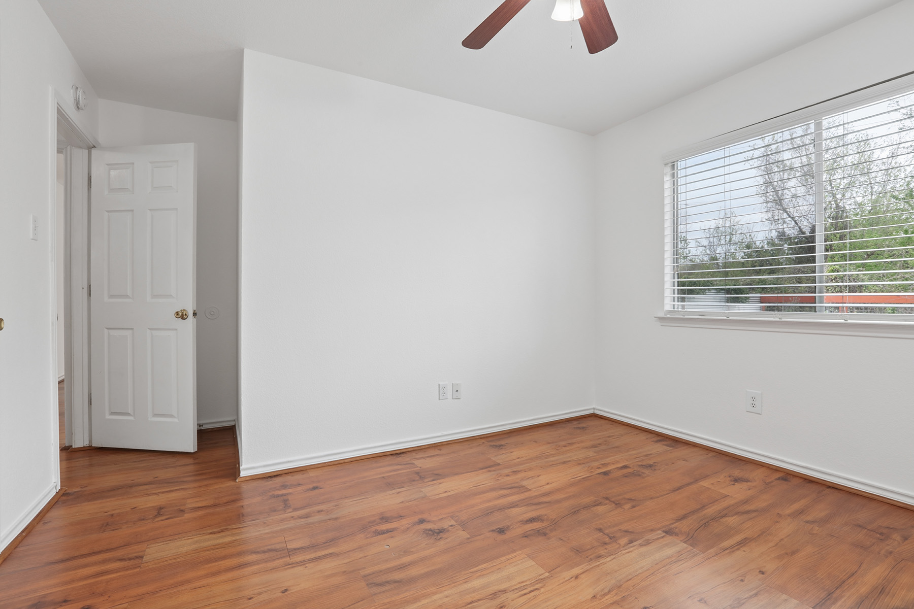 12319 Turtle Rock Road, Unit B Austin, TX 78729 - Photo 16 of 26 wooden floor in an empty room with a window