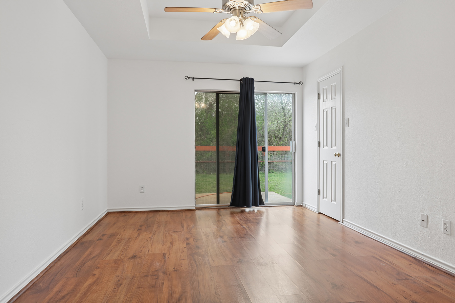12319 Turtle Rock Road, Unit B Austin, TX 78729 - Photo 18 of 26 wooden floor in an empty room with a window