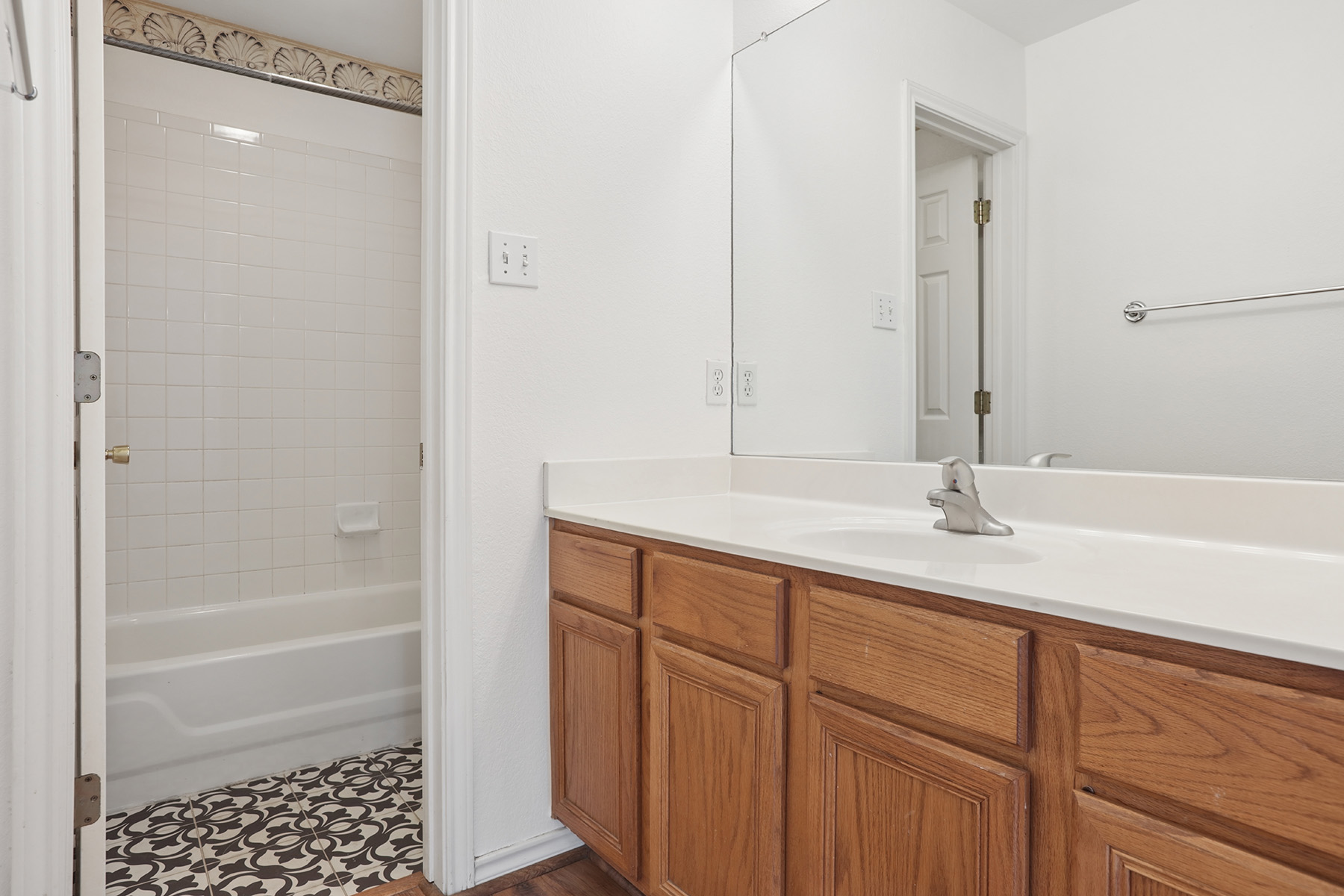 12319 Turtle Rock Road, Unit B Austin, TX 78729 - Photo 20 of 26 a bathroom with a shower a sink and a mirror