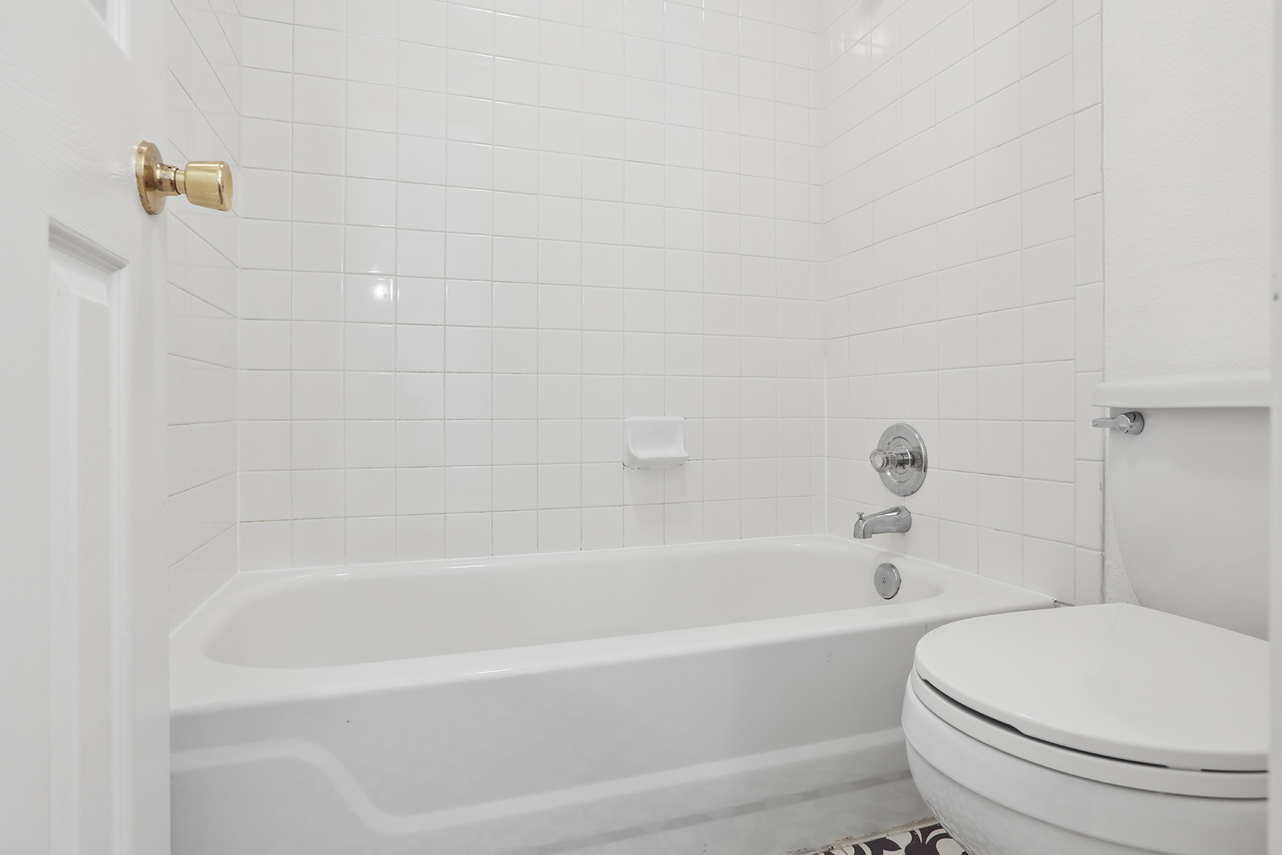 12319 Turtle Rock Road, Unit B Austin, TX 78729 - Photo 21 of 26 a white bath tub sitting next to a white toilet and sink