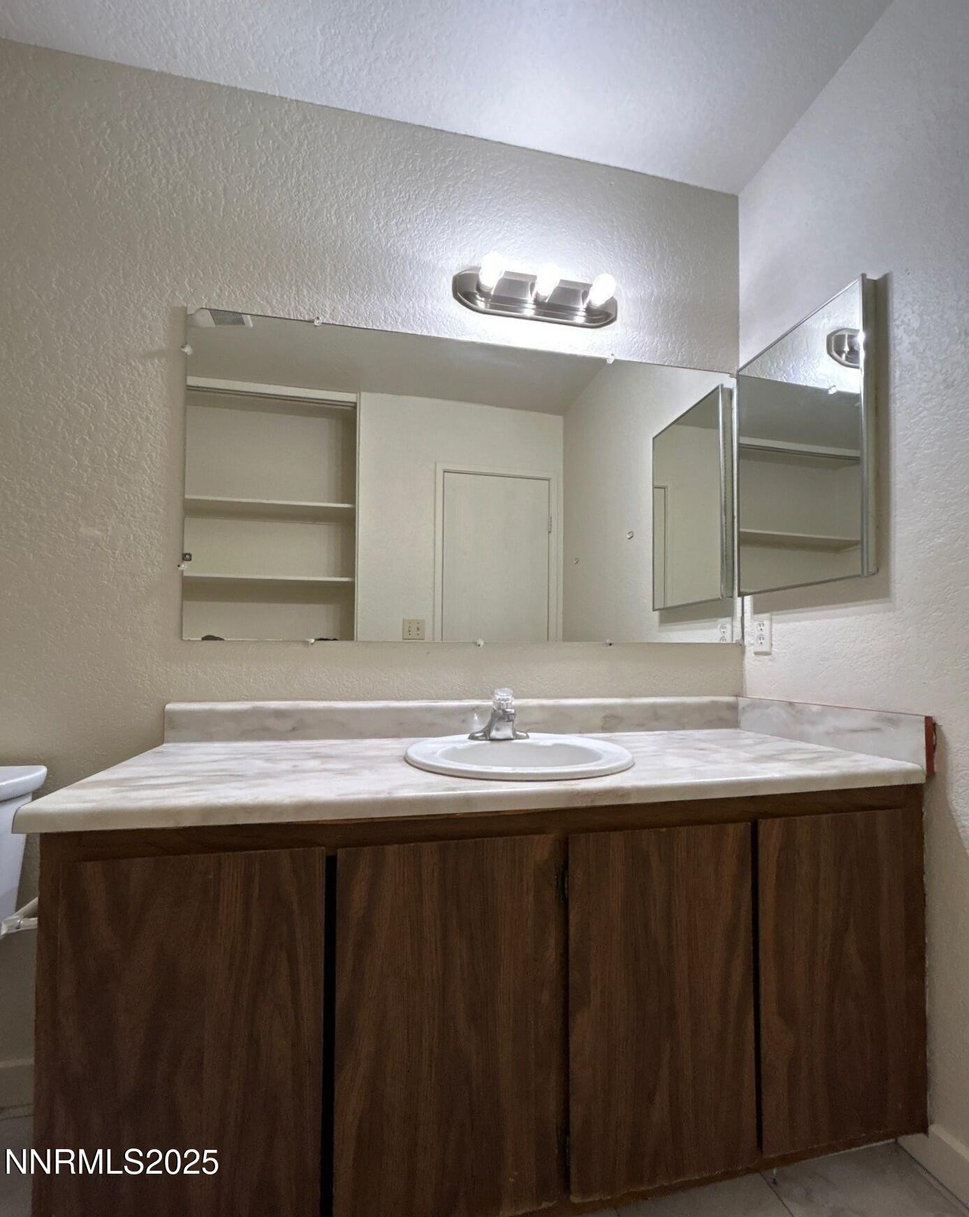 4604 Neil Road, Unit 98 Reno, NV 89502 - Photo 13 of 16 a bathroom with a sink and a mirror