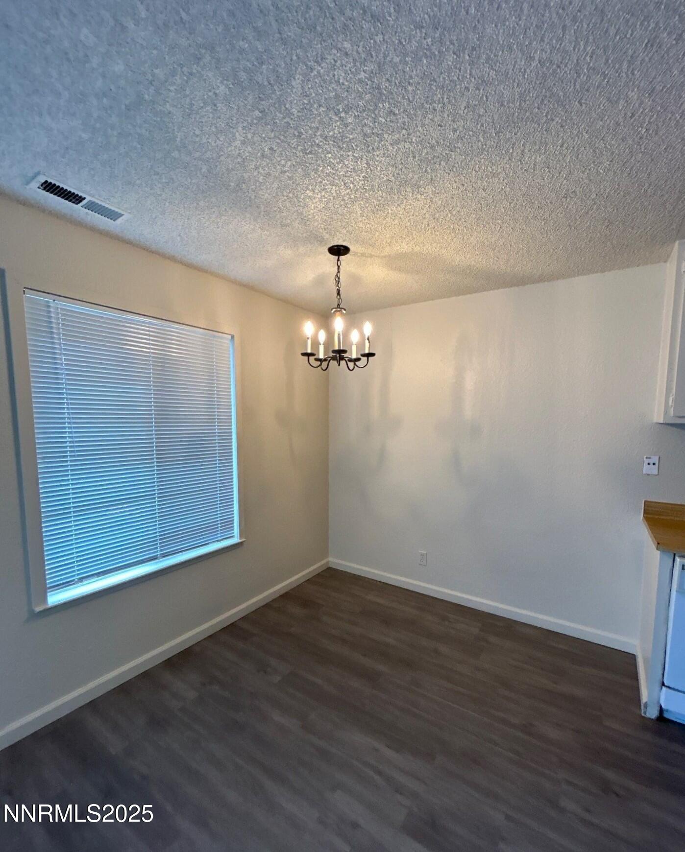 4604 Neil Road, Unit 98 Reno, NV 89502 - Photo 6 of 16 wooden floor in an empty room with a window