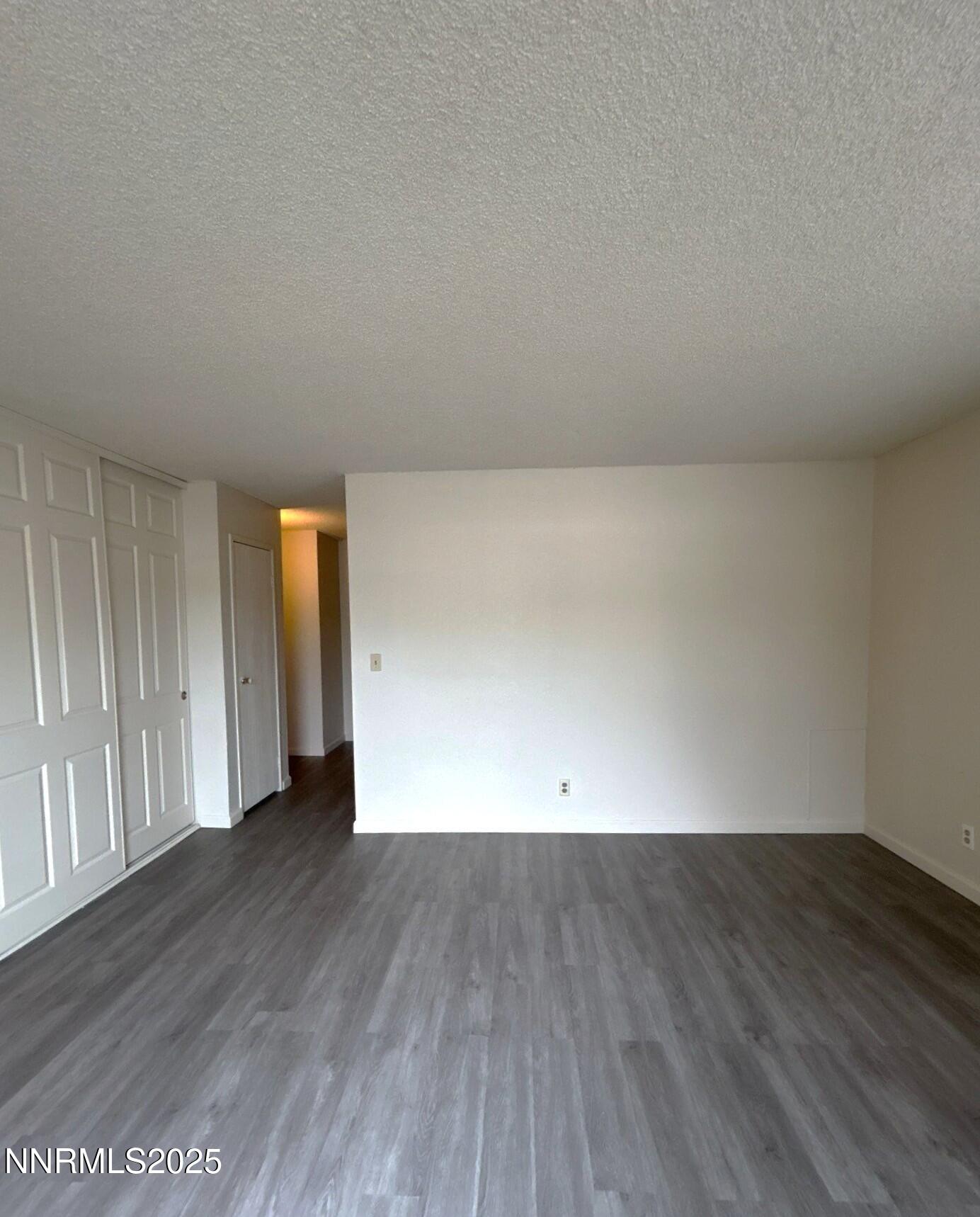 4604 Neil Road, Unit 98 Reno, NV 89502 - Photo 9 of 16 a view of an empty room with wooden floor