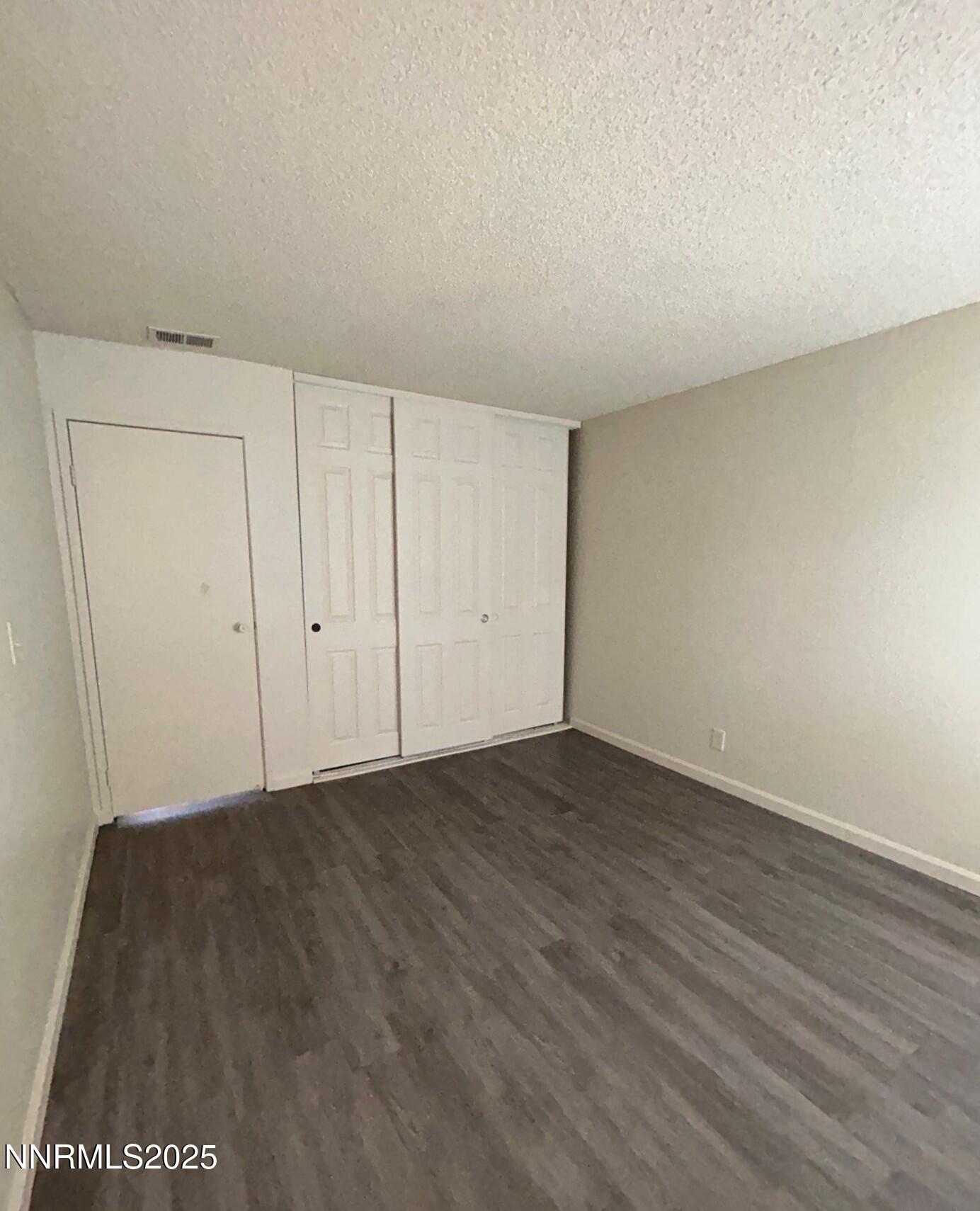 4604 Neil Road, Unit 98 Reno, NV 89502 - Photo 10 of 16 a view of an empty room and wooden floor