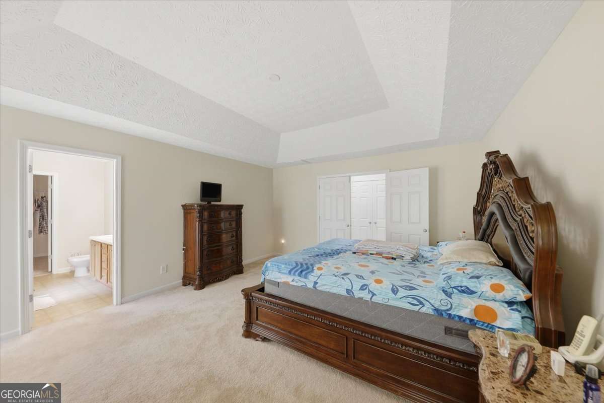 3867 Riverside Parkway Decatur, GA 30034 - Photo 11 of 23 a bedroom with a bed and a walk in closet
