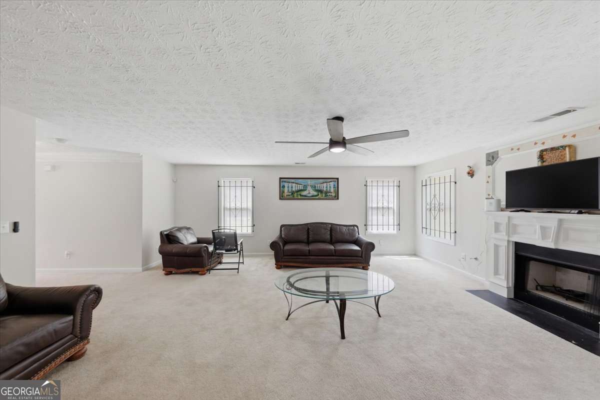 3867 Riverside Parkway Decatur, GA 30034 - Photo 6 of 23 a living room with furniture a flat screen tv and a fireplace