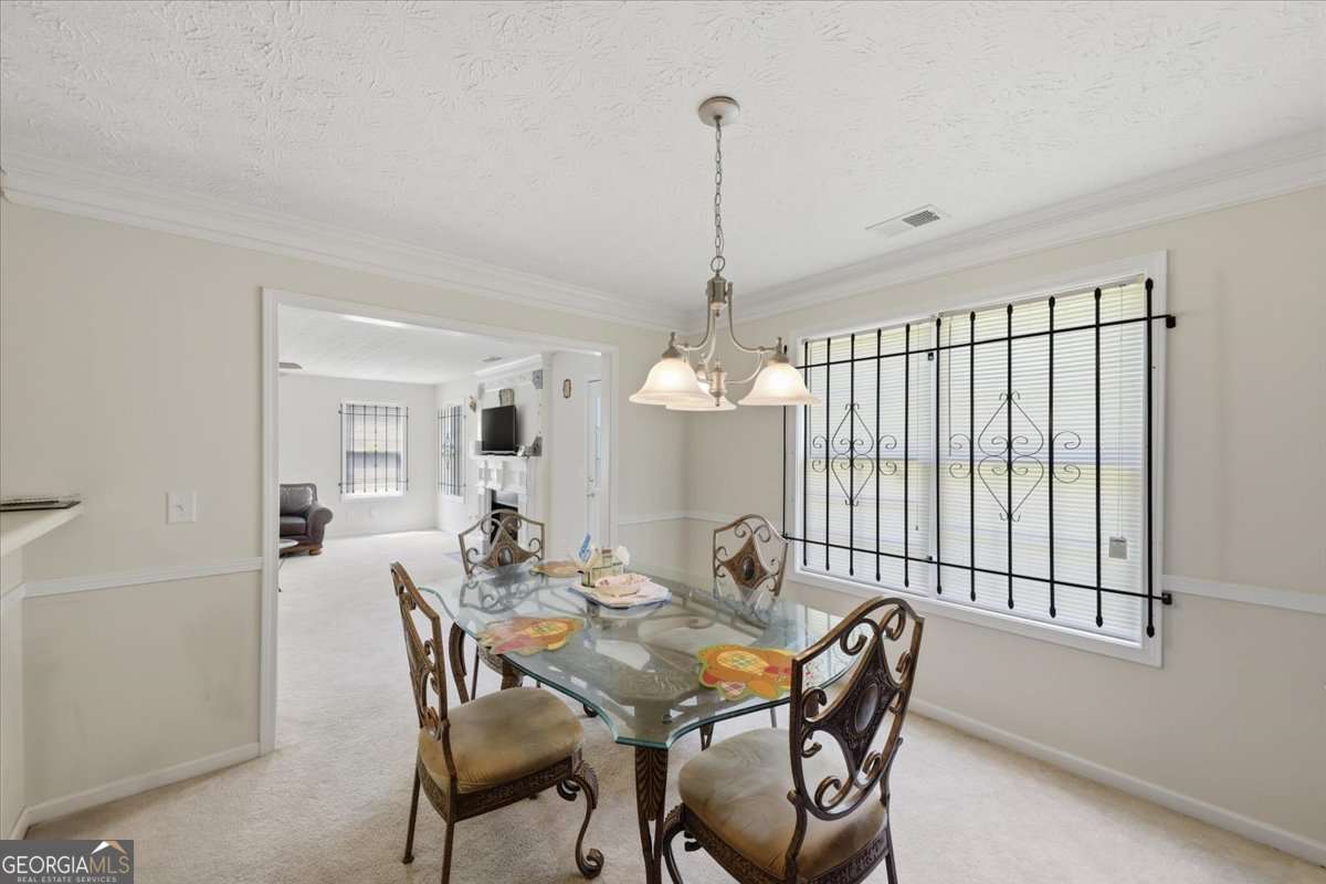 3867 Riverside Parkway Decatur, GA 30034 - Photo 8 of 23 a view of a dining room with furniture and chandelier