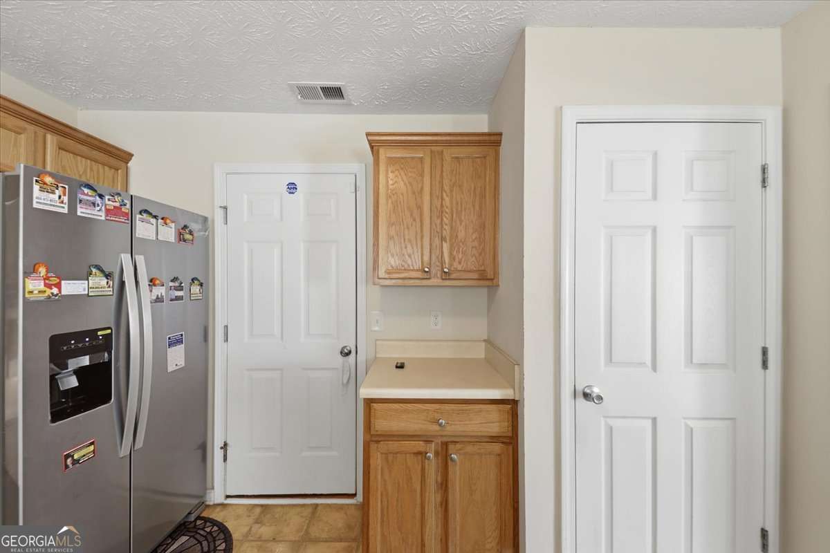 3867 Riverside Parkway Decatur, GA 30034 - Photo 9 of 23 a bathroom with a refrigerator a sink and cabinets