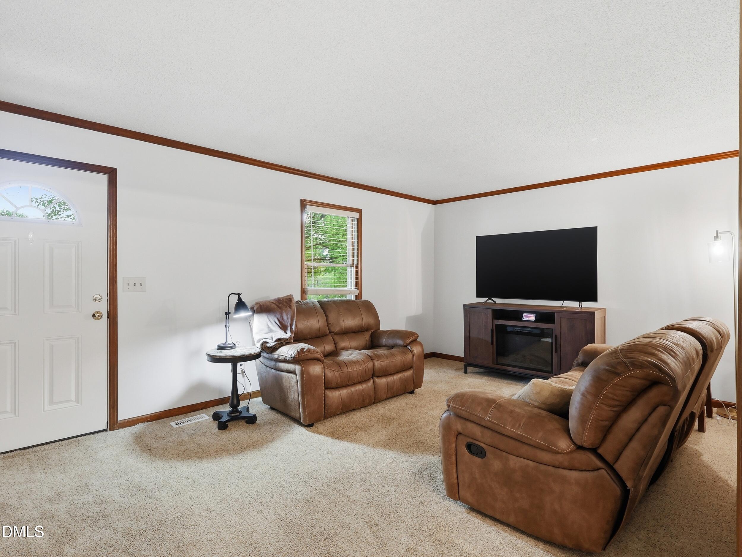 517 Lake Glad Road Wendell, NC 27591 - Photo 6 of 36 a living room with furniture and a flat screen tv