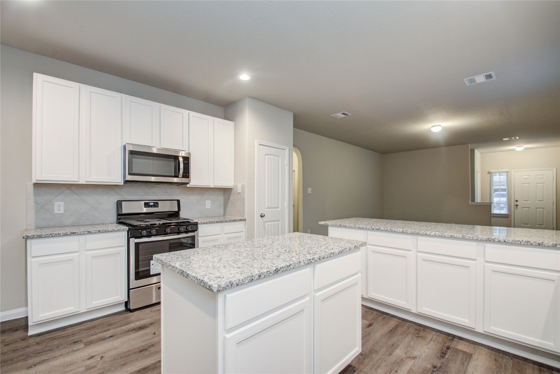 3620 Cub Drive Conroe, TX 77301 - Photo 11 of 49 a kitchen that has a sink and a stove in it