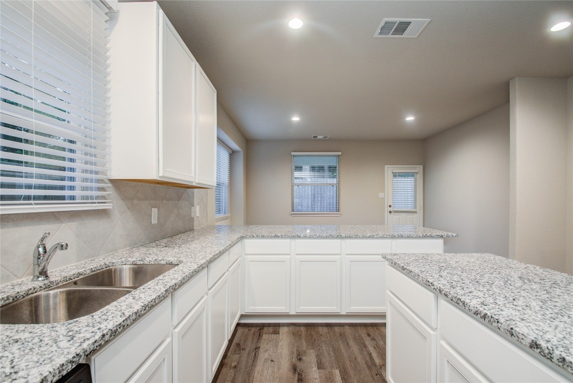 3620 Cub Drive Conroe, TX 77301 - Photo 13 of 49 a kitchen with a sink stove and cabinets