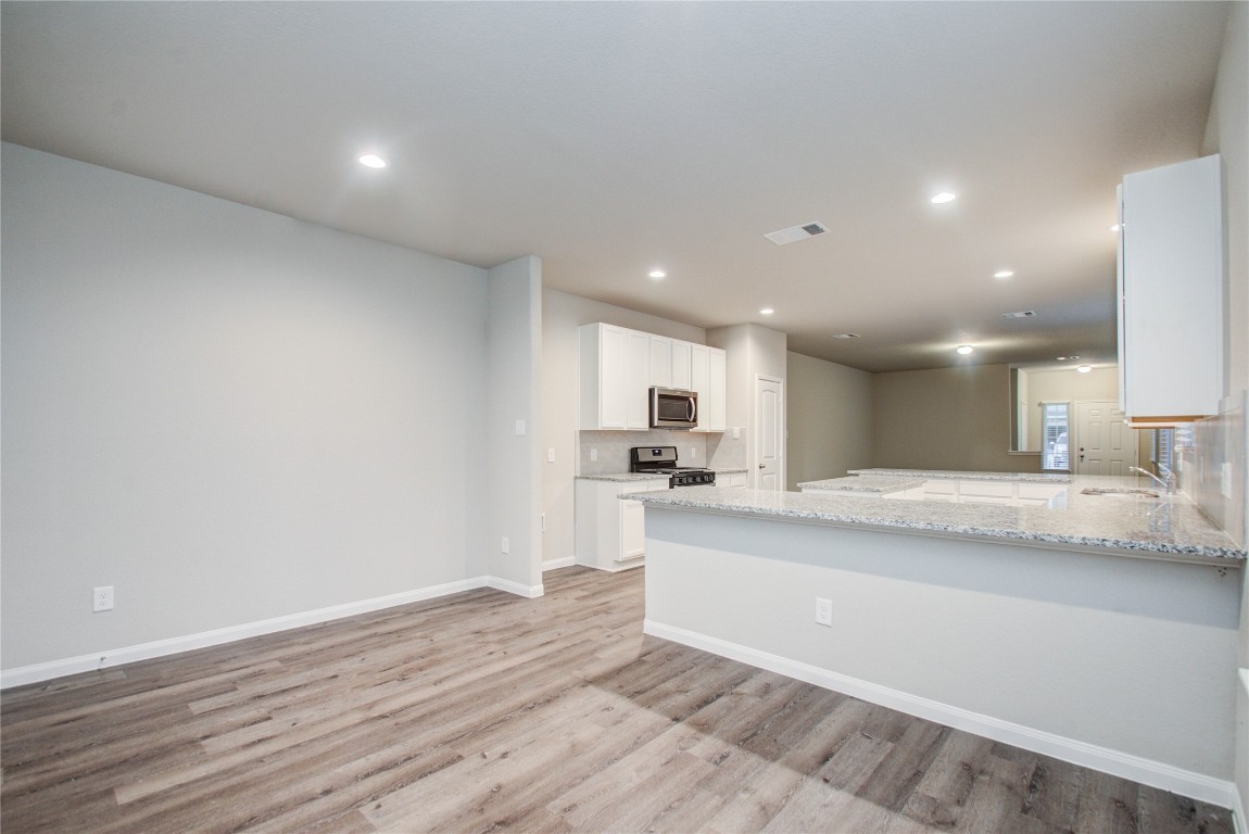 3620 Cub Drive Conroe, TX 77301 - Photo 15 of 49 a view of kitchen with kitchen island a sink dishwasher and a stove with wooden floor