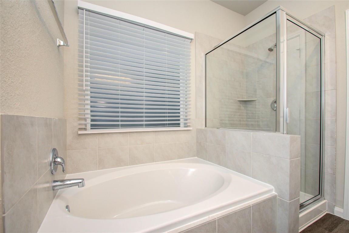 3620 Cub Drive Conroe, TX 77301 - Photo 19 of 49 a bathroom with a bathtub and a shower