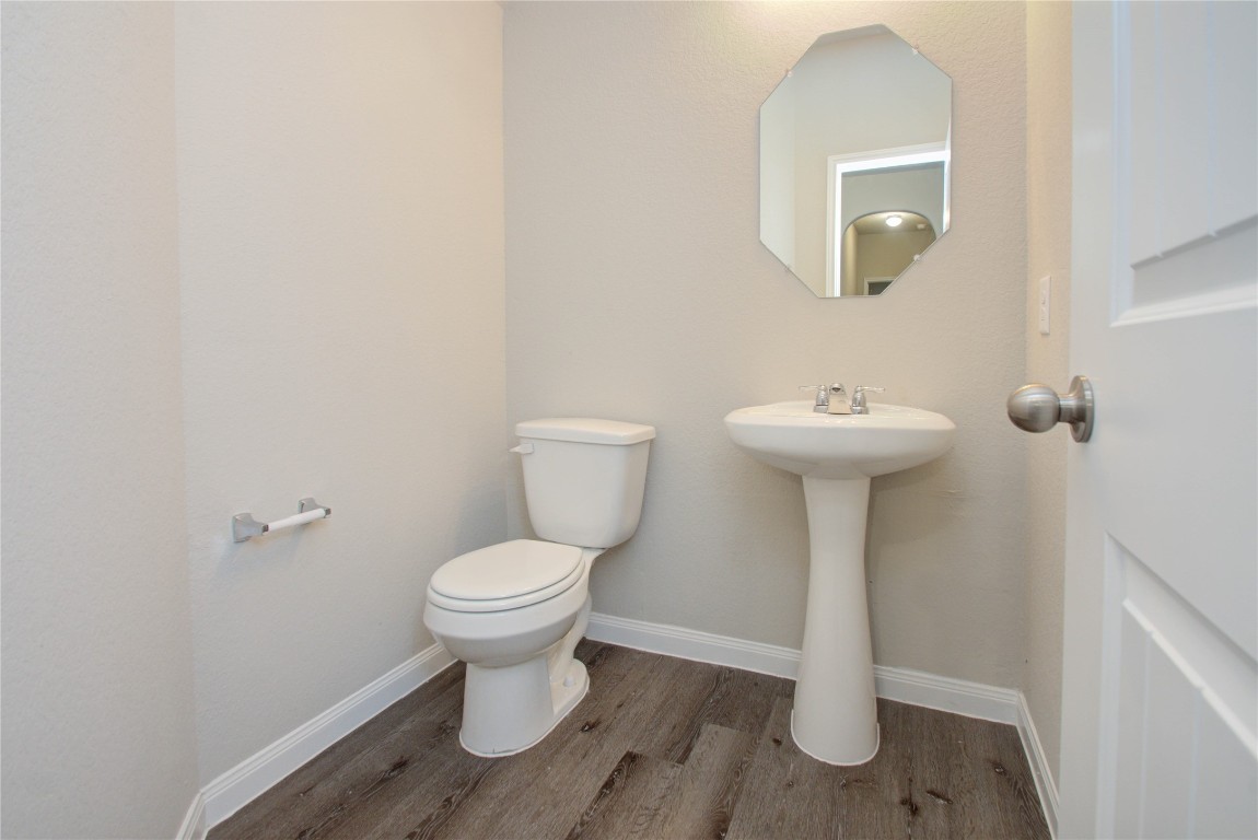 3620 Cub Drive Conroe, TX 77301 - Photo 22 of 49 a bathroom with a toilet sink and mirror