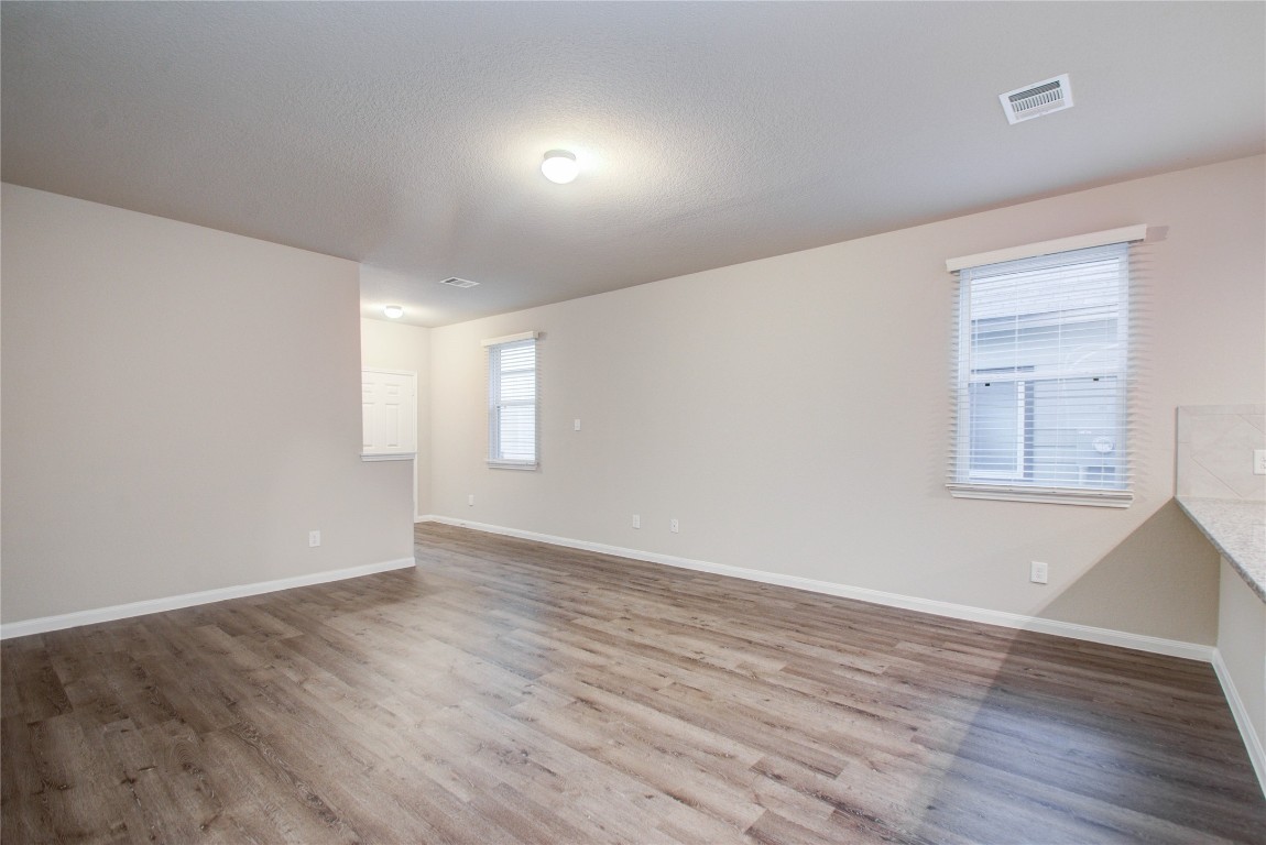 3620 Cub Drive Conroe, TX 77301 - Photo 7 of 49 an empty room with wooden floor and windows