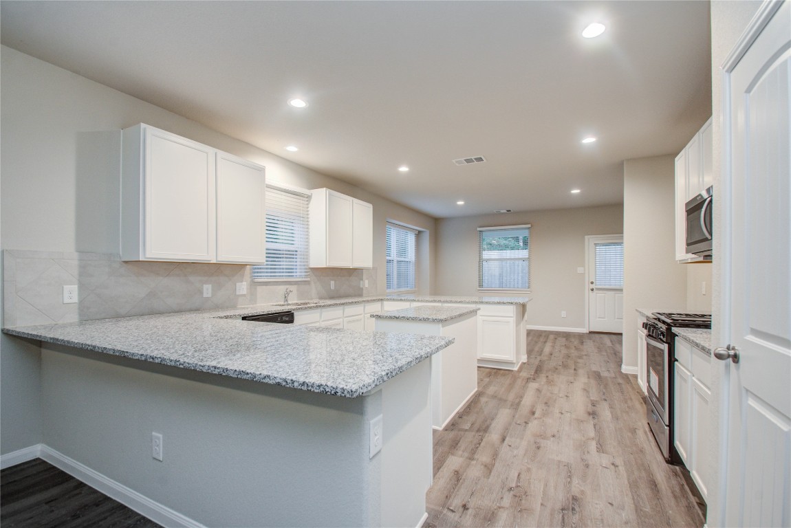 3620 Cub Drive Conroe, TX 77301 - Photo 9 of 49 a large kitchen with granite countertop a large counter top covered in it