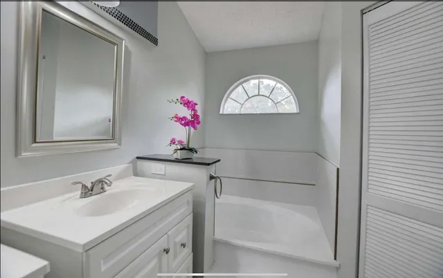 a bathroom with a sink and a mirror