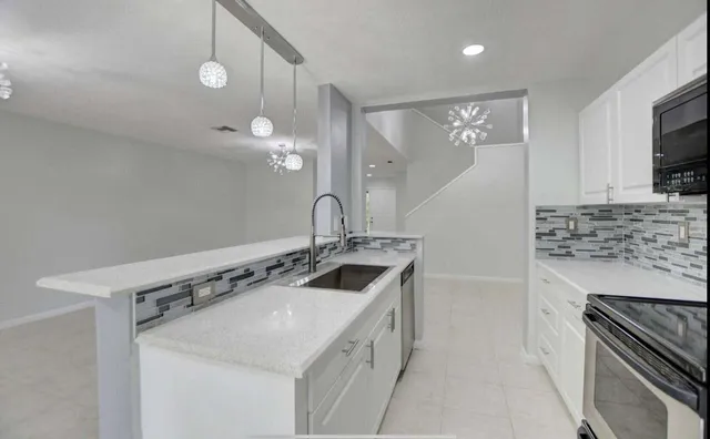 a kitchen with a sink stove and microwave