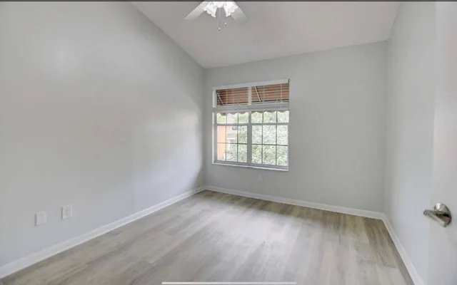 wooden floor in an empty room with a window