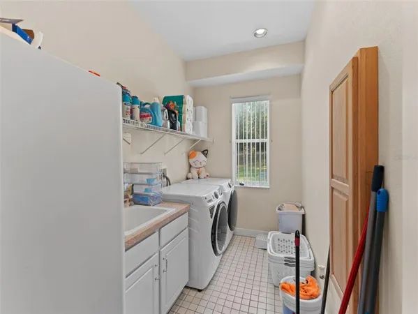 a utility room with sink dryer and washer