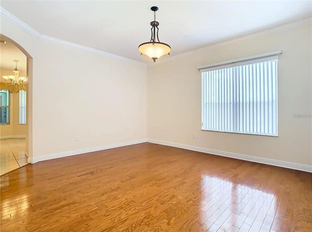 11361 Science Drive Brooksville, FL 34601 - Photo 17 of 31 wooden floor in an empty room with a window
