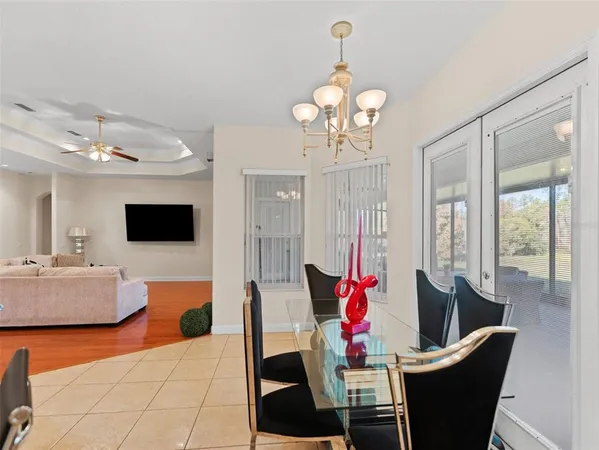 a view of a dining room with furniture and chandelier