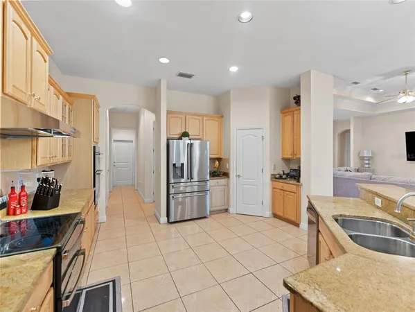 a kitchen with stainless steel appliances a refrigerator and a sink