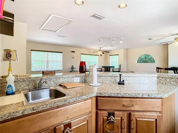 a kitchen with granite countertop a sink and a stove