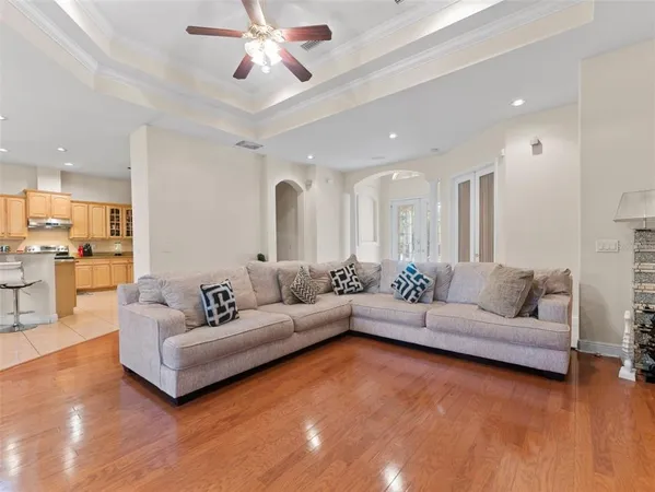 a living room with furniture and kitchen view