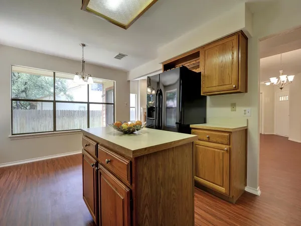 a kitchen with stainless steel appliances granite countertop a sink a stove and a wooden floors