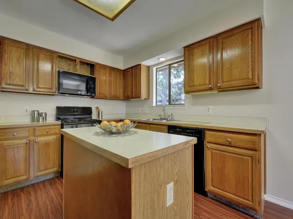 a kitchen with stainless steel appliances granite countertop a sink stove and microwave