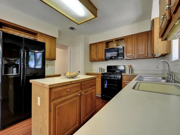 a kitchen with a stove and a sink