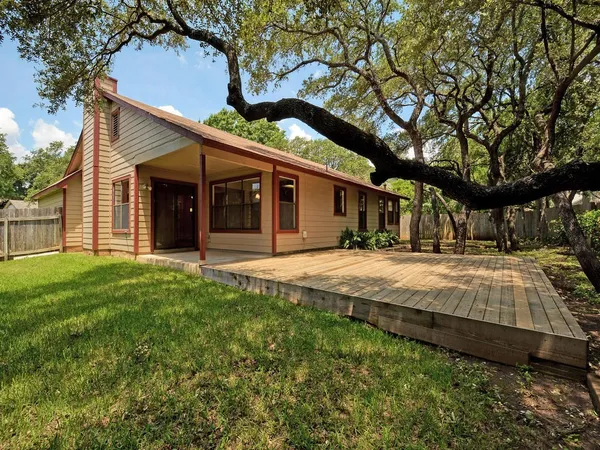 a house with huge green field in front of it
