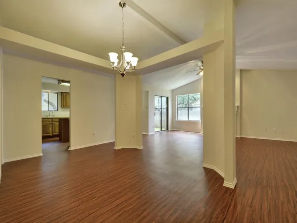 a view of a livingroom with a furniture wooden floor and chandelier