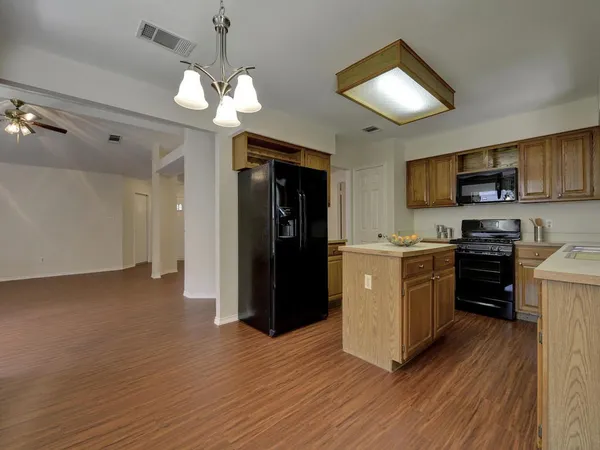 a kitchen with a refrigerator a stove top oven a sink and dishwasher