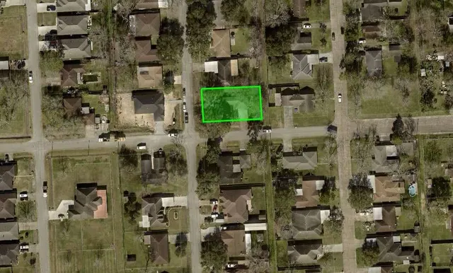 an aerial view of a residential apartment building with a yard