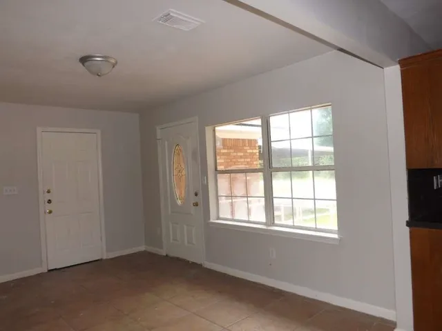 a view of an empty room with a window