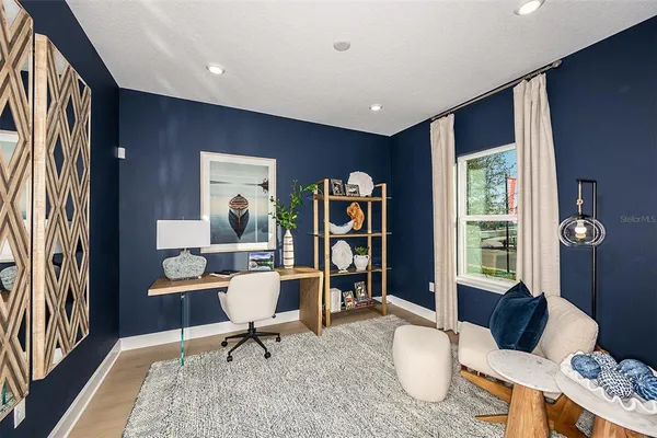 a living room with furniture a window and a flat screen tv