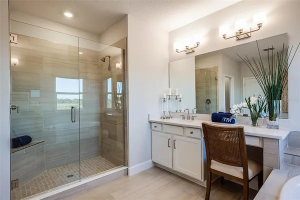 a bathroom with a double vanity sink mirror and shower
