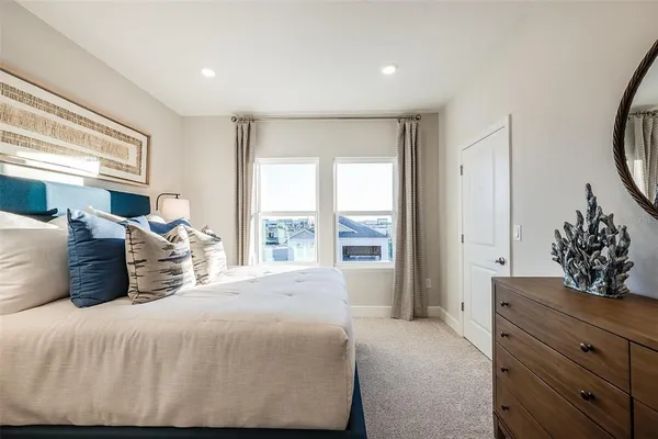 a bedroom with a large bed and a window